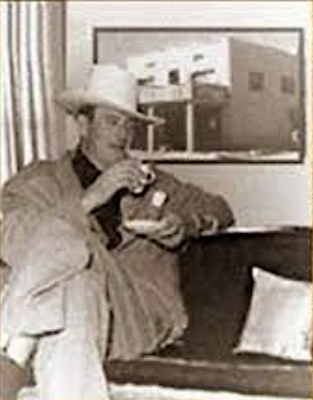 John Wayne sipping coffee with Cottonwood Hotel pic behind him